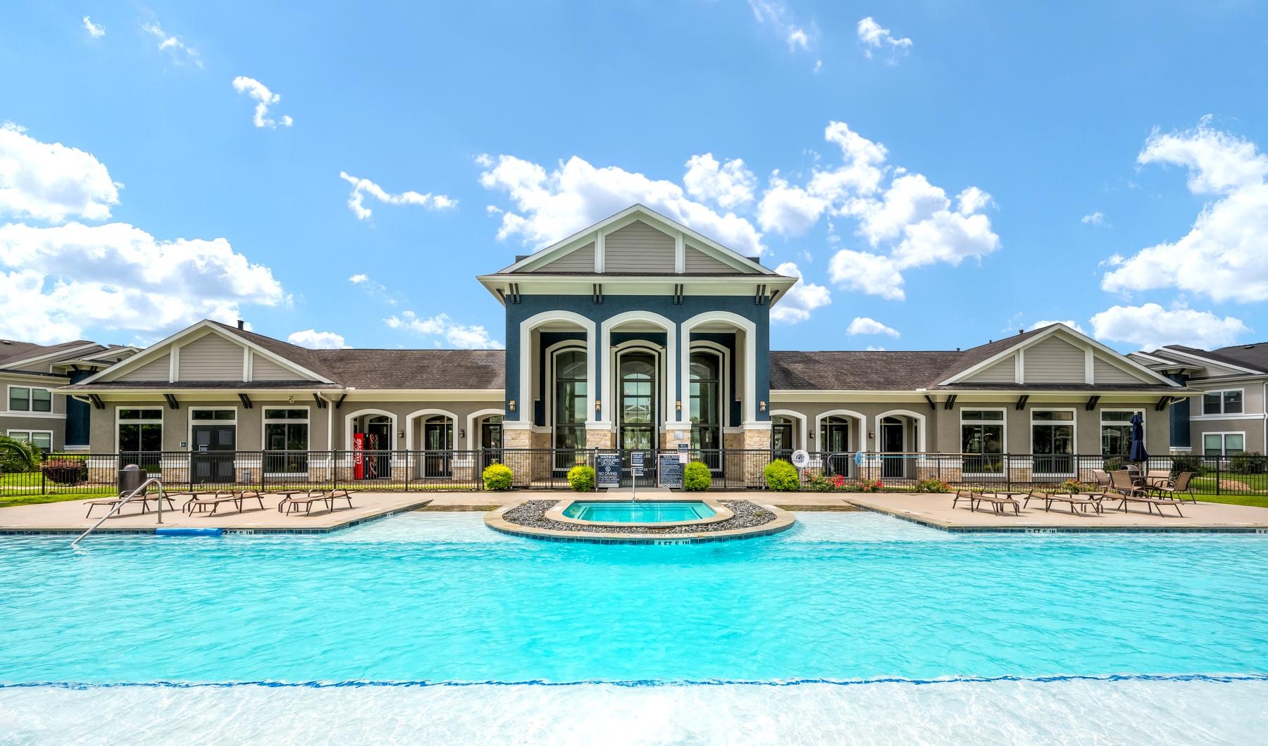 a large building with a pool in front of it