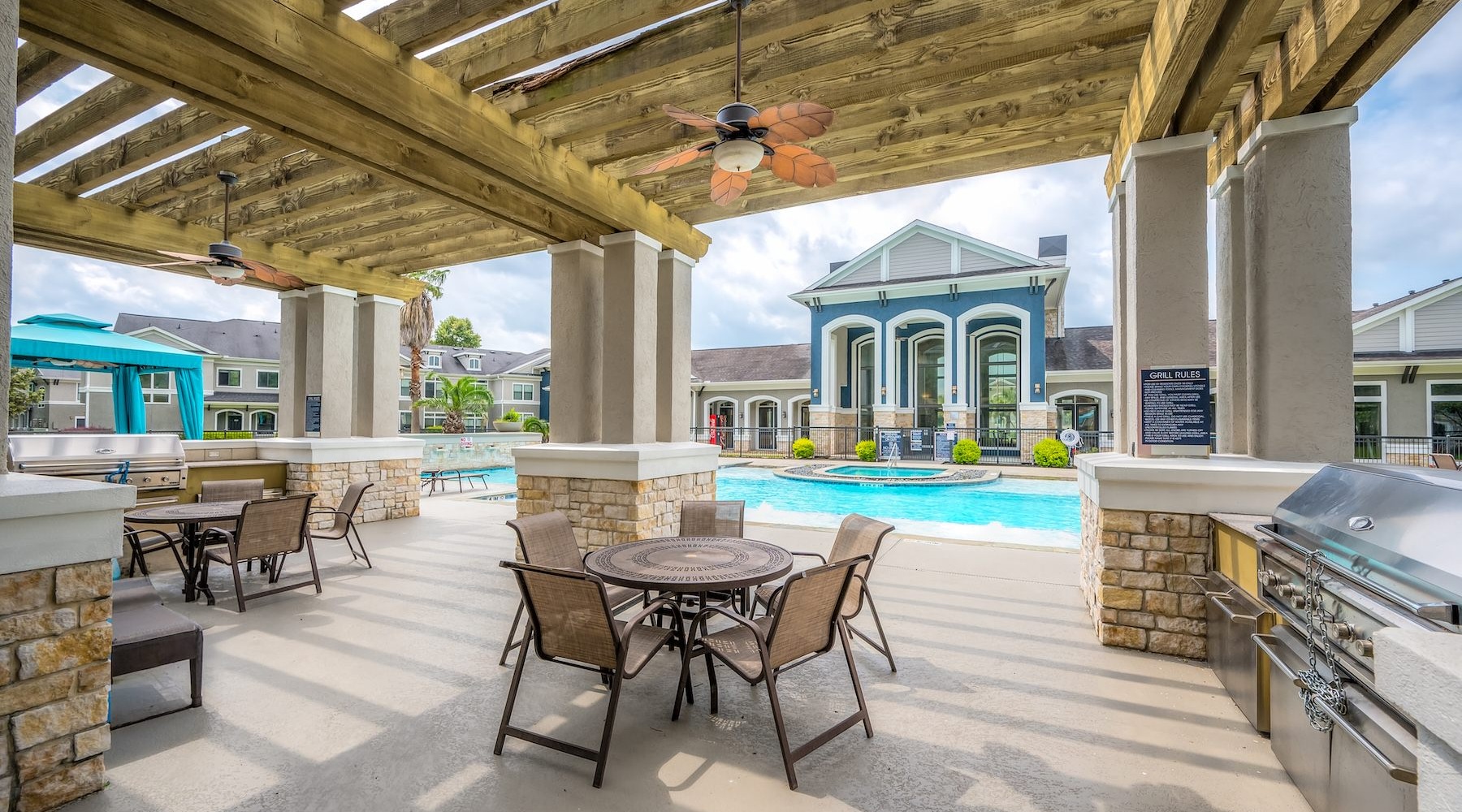 a grill area with tables and chairs